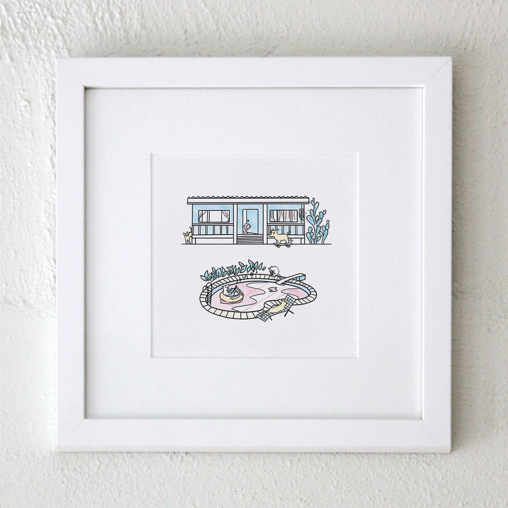A white framed fine art Hound Town print square format - the artwork features a fishermans cottage with a cartoon dog skating past, a cactus and a cat, and in front there is a pool with a dog jumping from the diing board, a labrador singing with a guitar and a kelpie on a deck chair all in pastel blue, pink and yellow