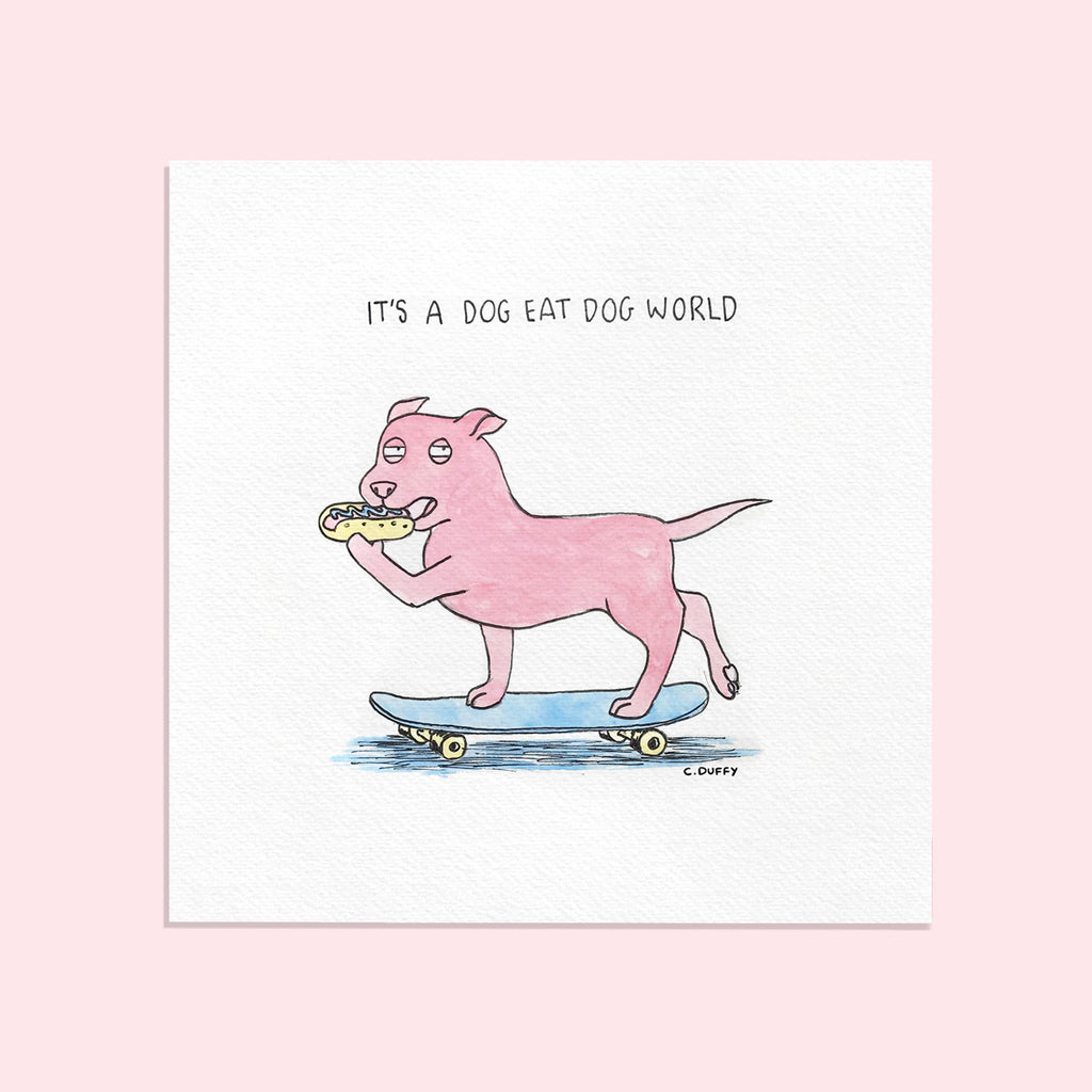 A fine art print on a pink background of a watercolour artwork featuring a cartoon staffy on a skateboard about to bite into a hotdog with a suspicious expression and words above that read "it's a dog eat dog world" the frame sits on a white textured wall artwork - Hound Town by Clare Duffy