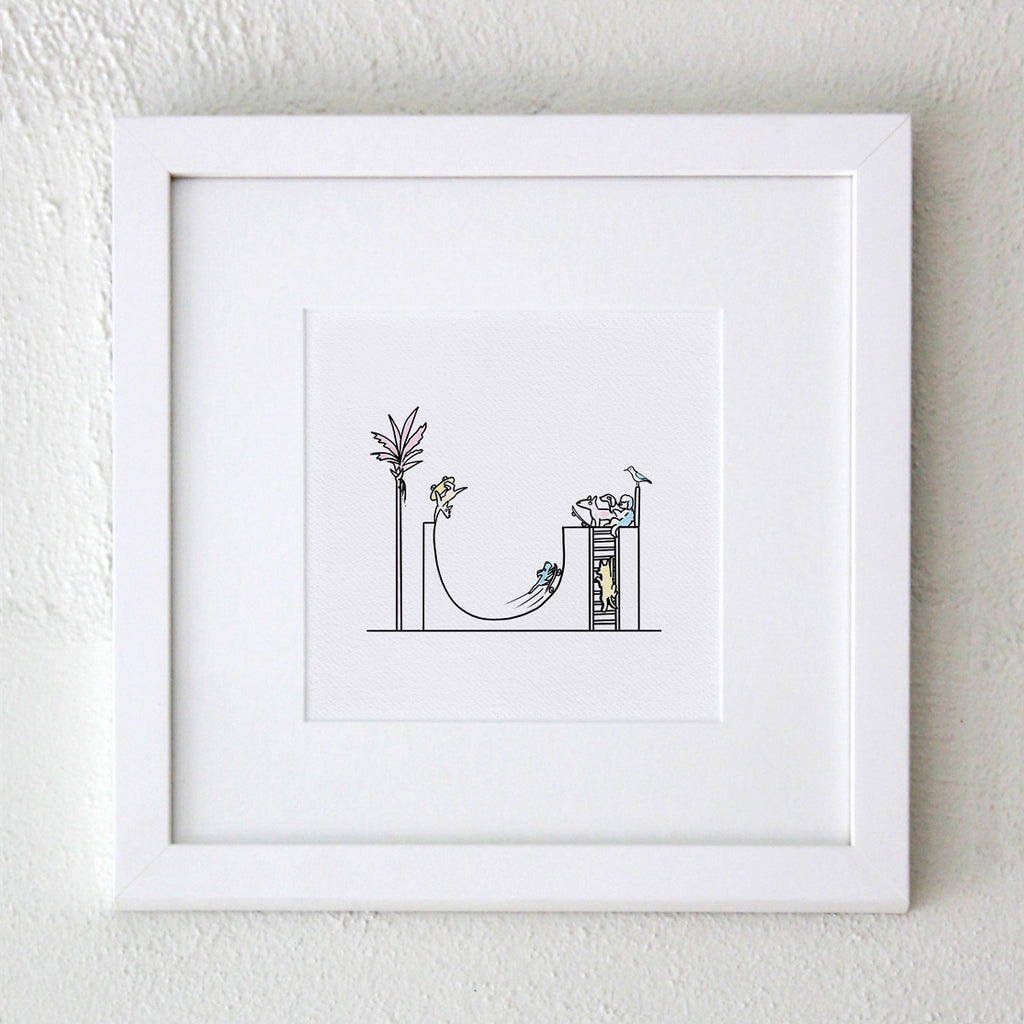 A white framed artwork with wide matt with digital illustration of a cartoon half pipe with dogs riding skateboards in Hound Town a pink palm tree and pastel blues, pinks and yellows but mainly white